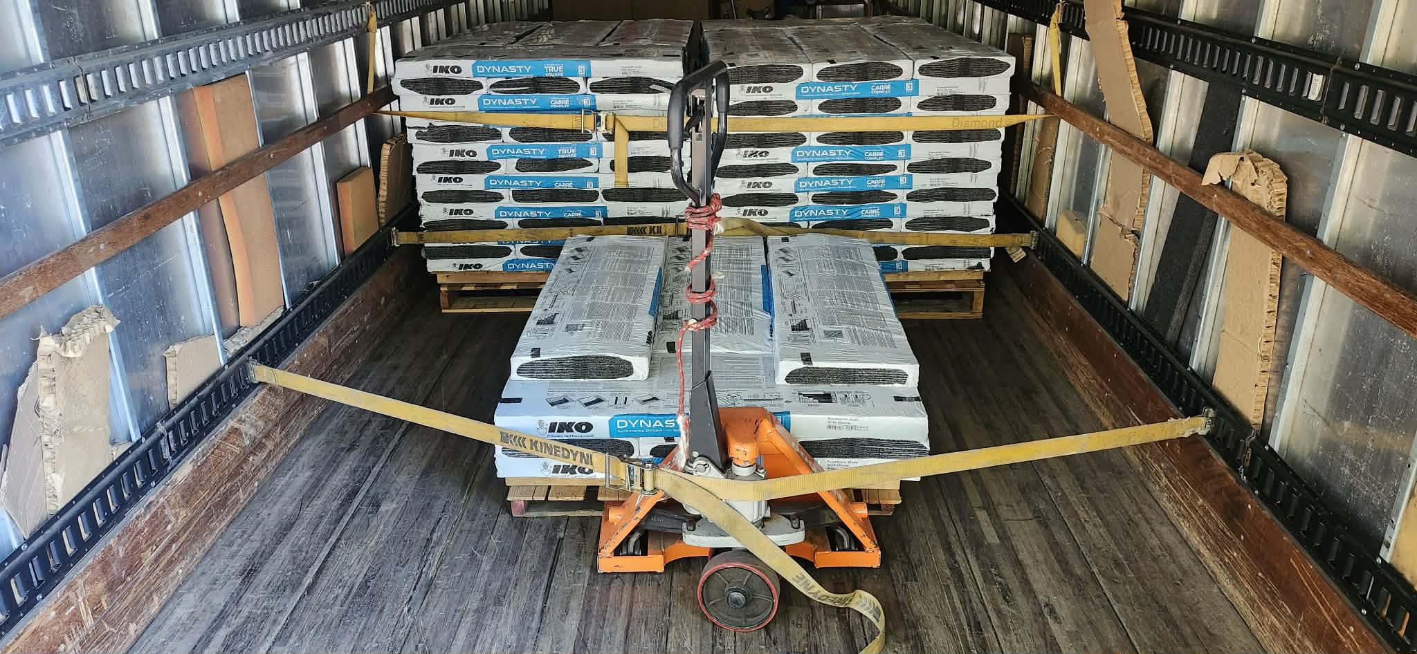 Heavy building materials secured on pallets inside the truck