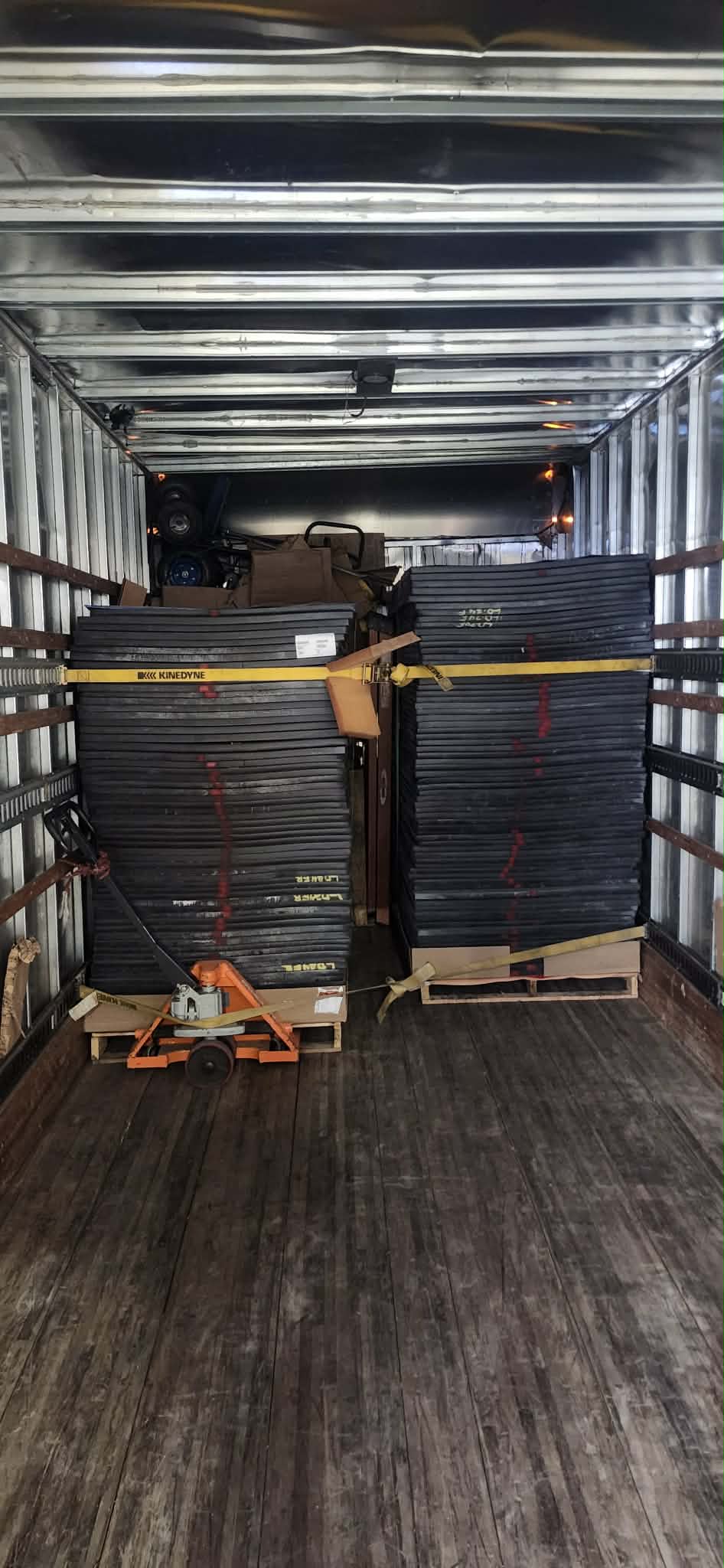 Heavy commercial items strapped and secured with ratchet straps inside moving truck
