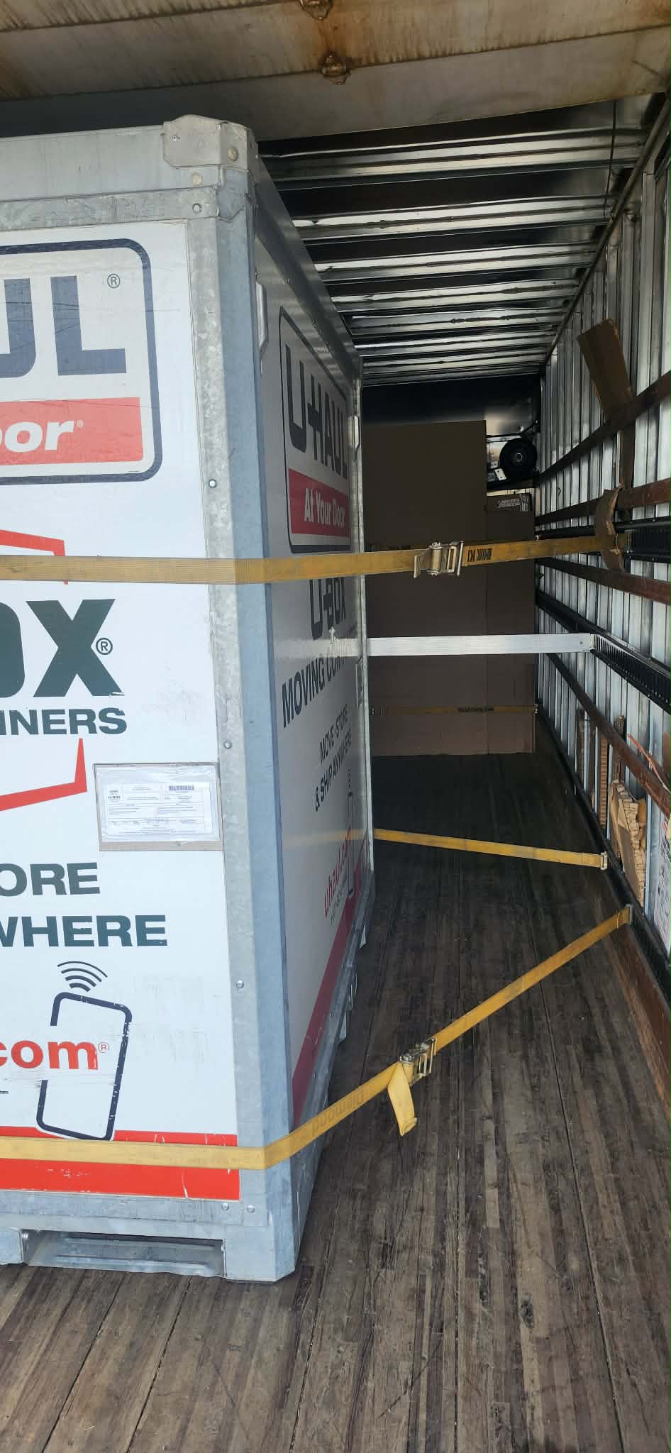 U-Box portable storage container loaded inside trailer for long-distance move from Seattle